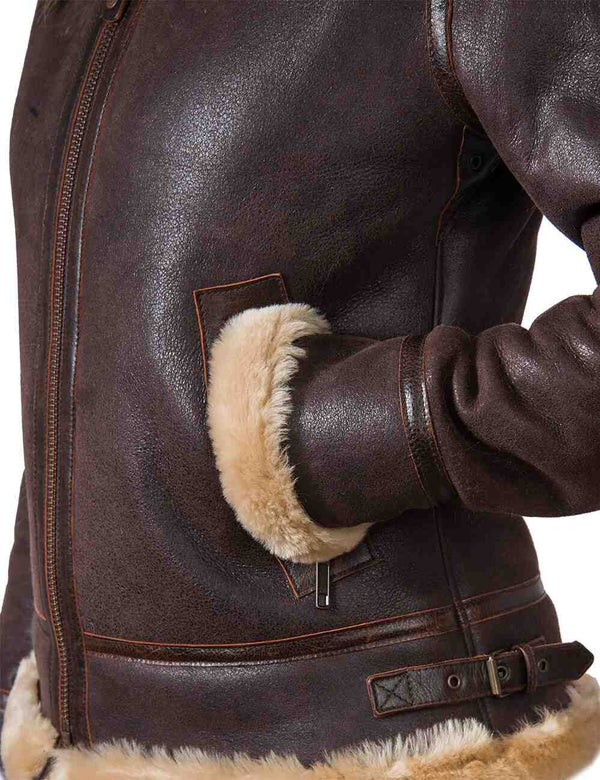 Lower left side of the women's short brown sheepskin coat, the sleeve in the pocket.